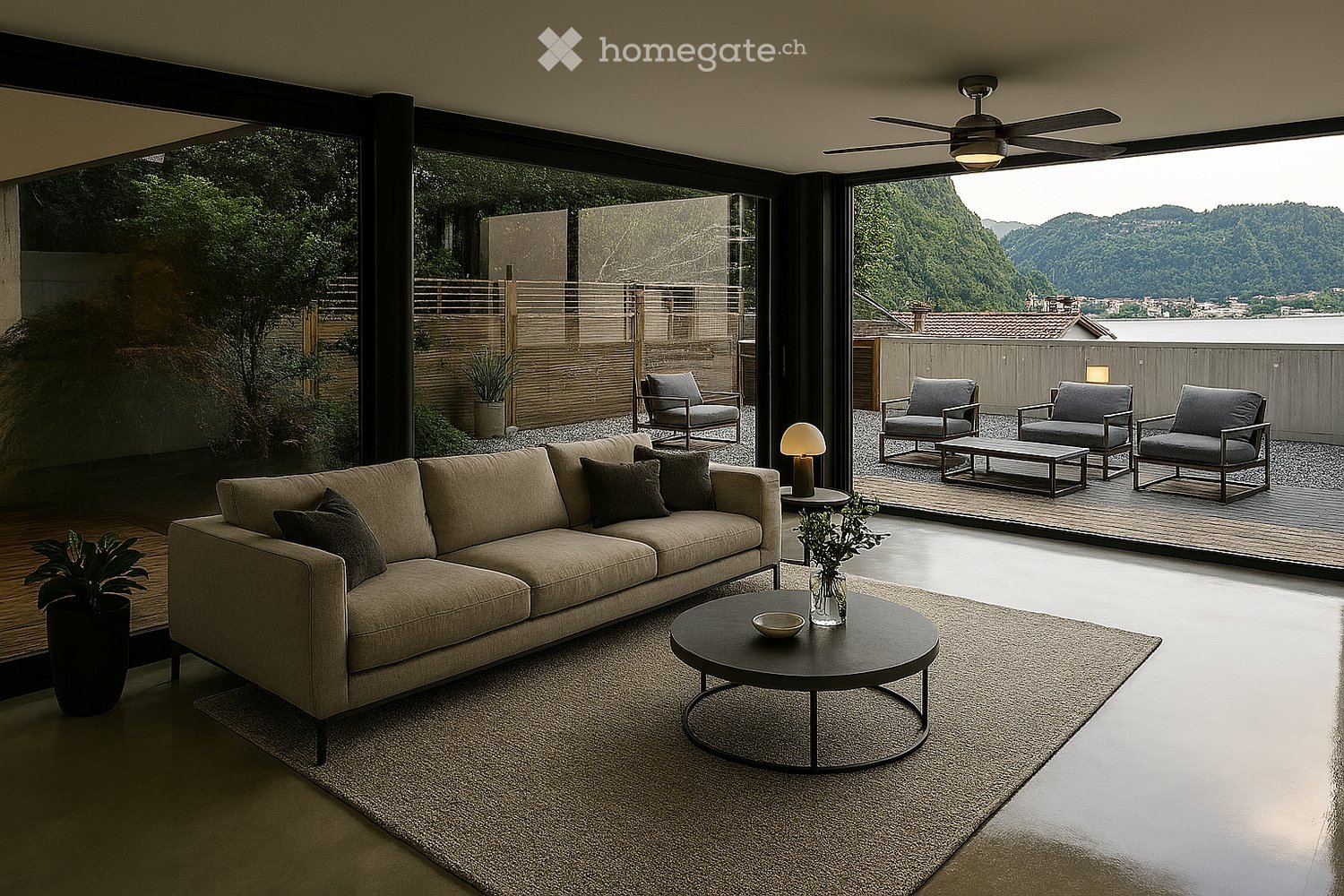 Spacious living room with large windows overlooking a scenic mountain view, comfortable beige sofa, black coffee table, and outdoor seating area on a covered patio