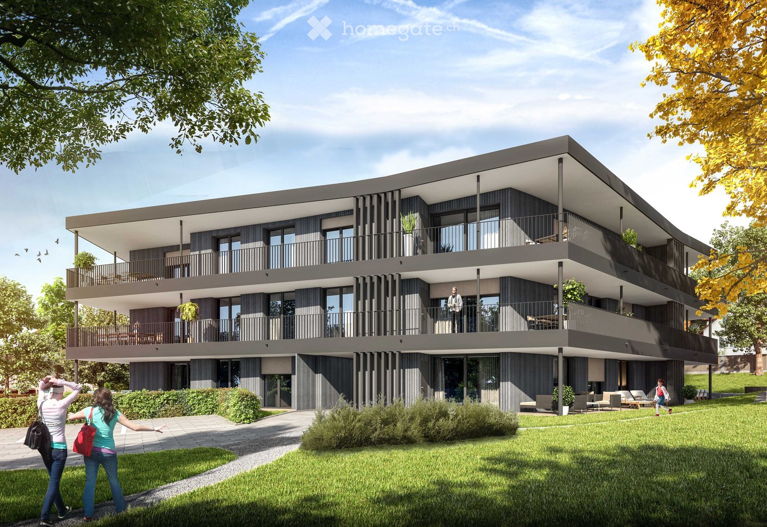 multi story building, grey exterior, balconies on each floor, windows, green grass and plants