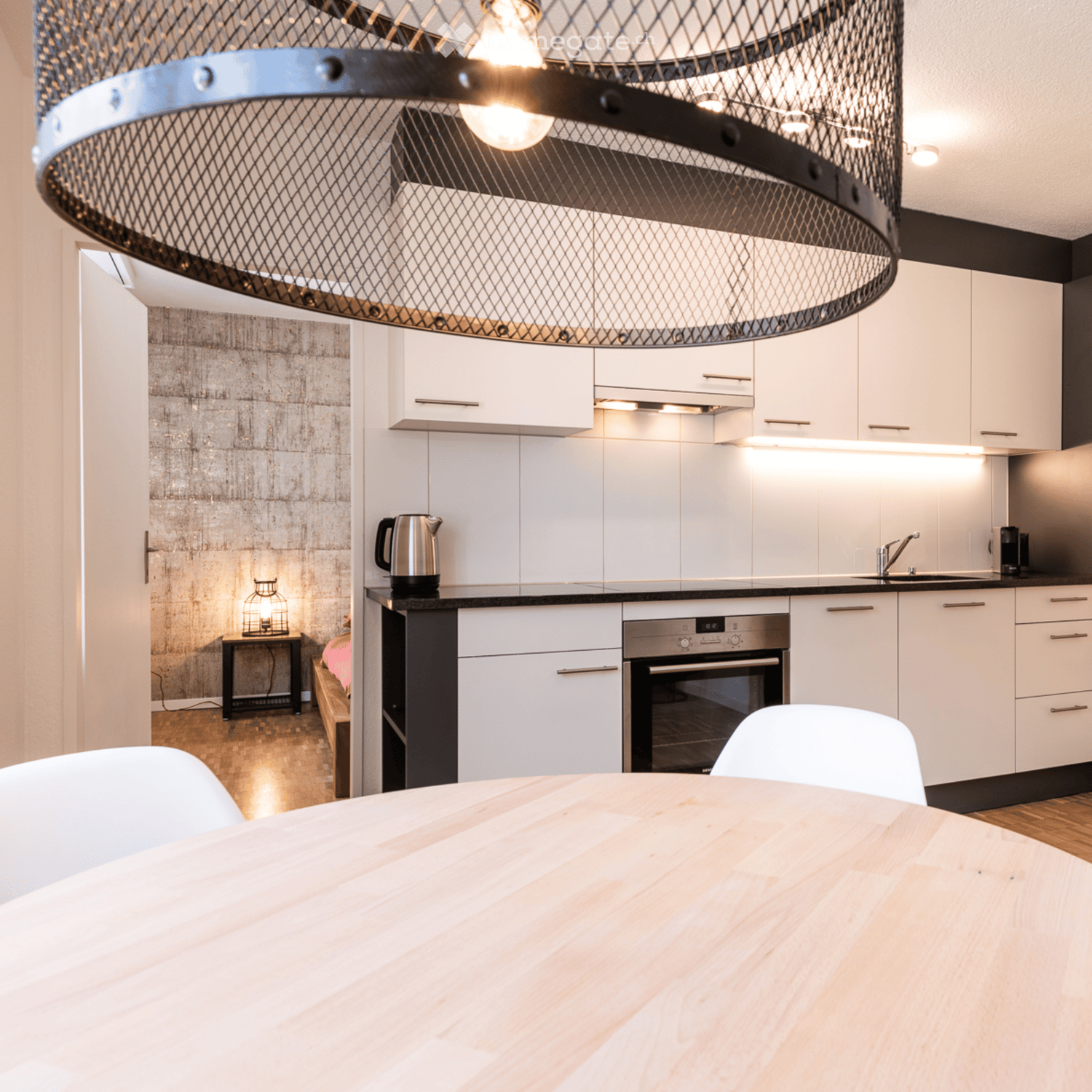 white cabinets, black countertop, white chairs, modern kitchen, black stove, stainless steel electric kettle, faucet, sink, lamp