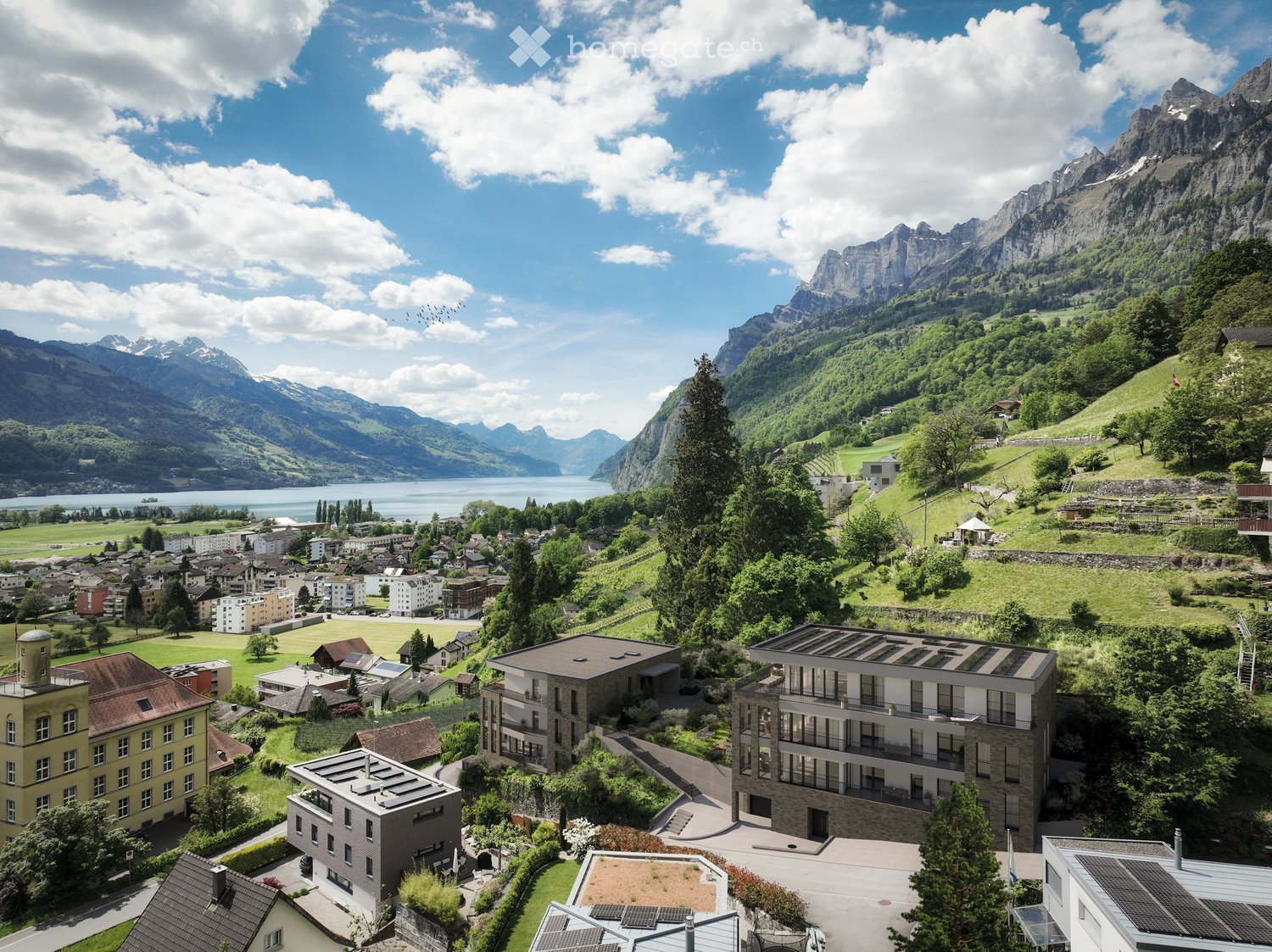 Residential building with green roof, mountain and lake view