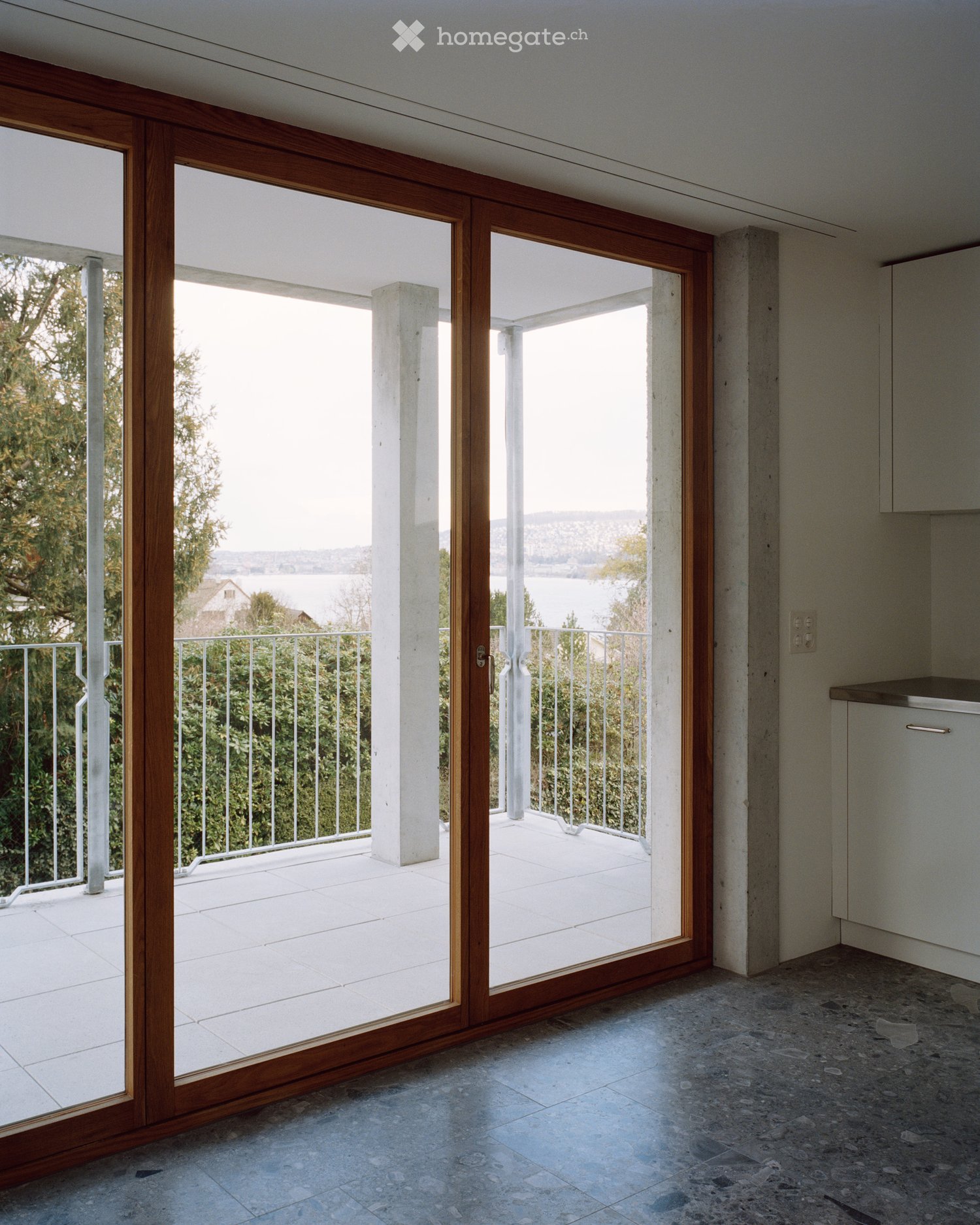 sliding wooden doors with a glass panel, large balcony, tiled floor, open view