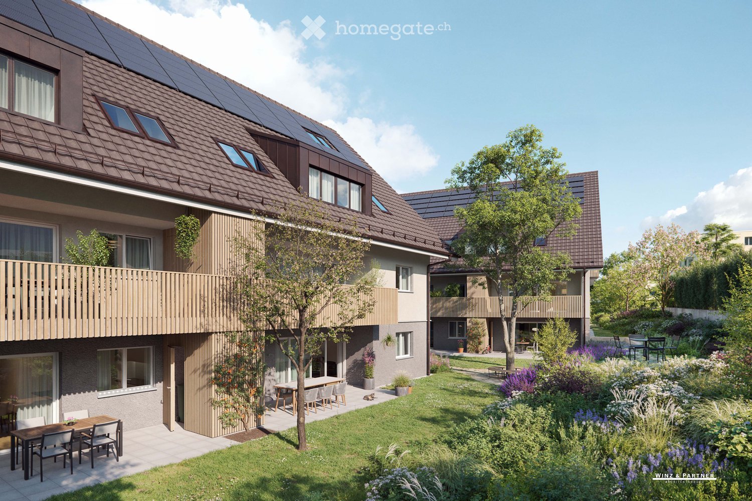 two-story building with solar panels on the roof, wooden balcony, patio, garden, and furniture