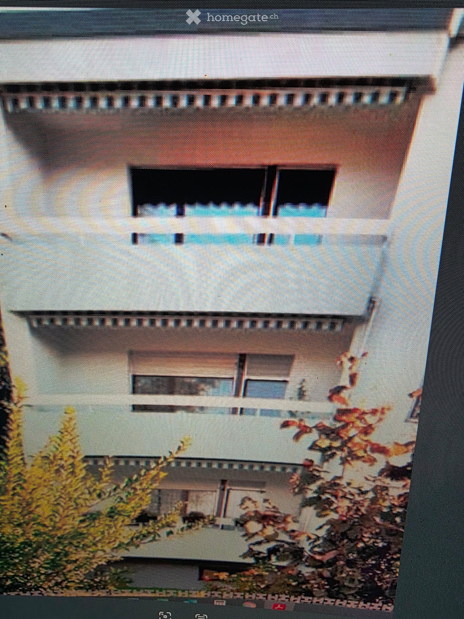 Multi-story building with balconies and awnings