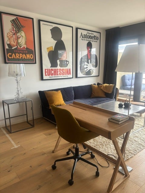 modern decor, blue sofa, desk, chair, wooden floors, paintings, lamps