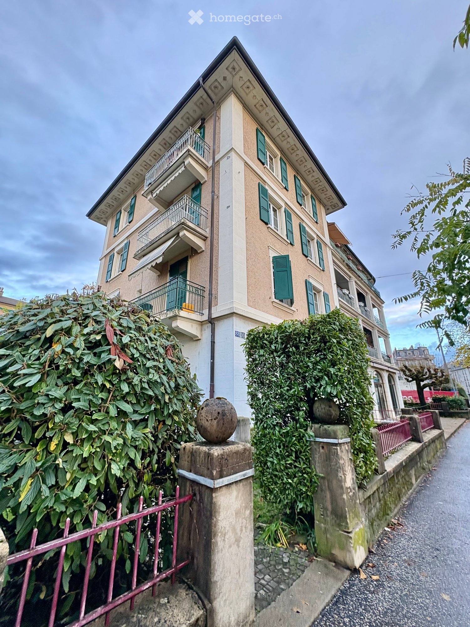 Three story apartment building with several balconies