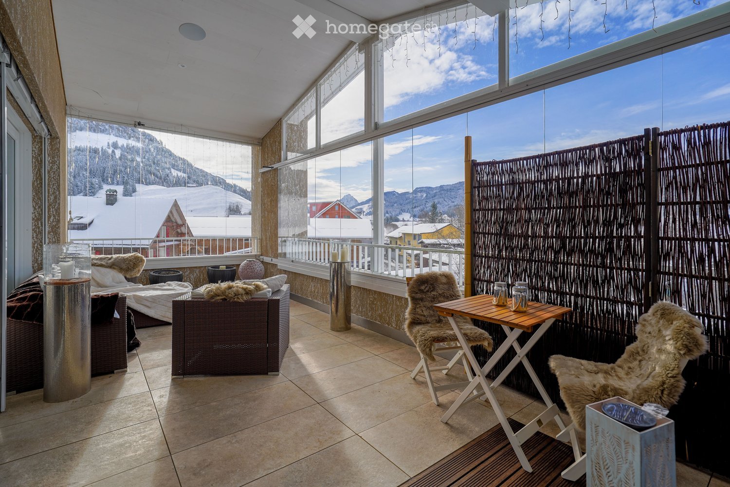 tiled floor, balcony, large windows, outdoor seating area, coffee table, armchairs, scenic mountain view