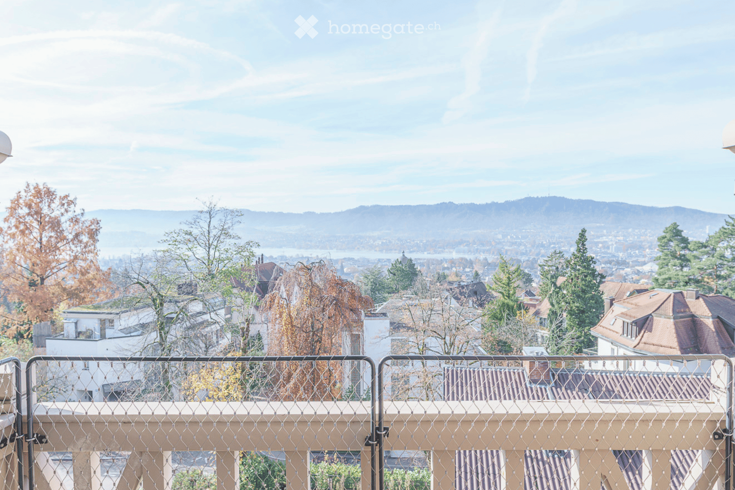 View from the balcony overlooking the mountains, city and lake