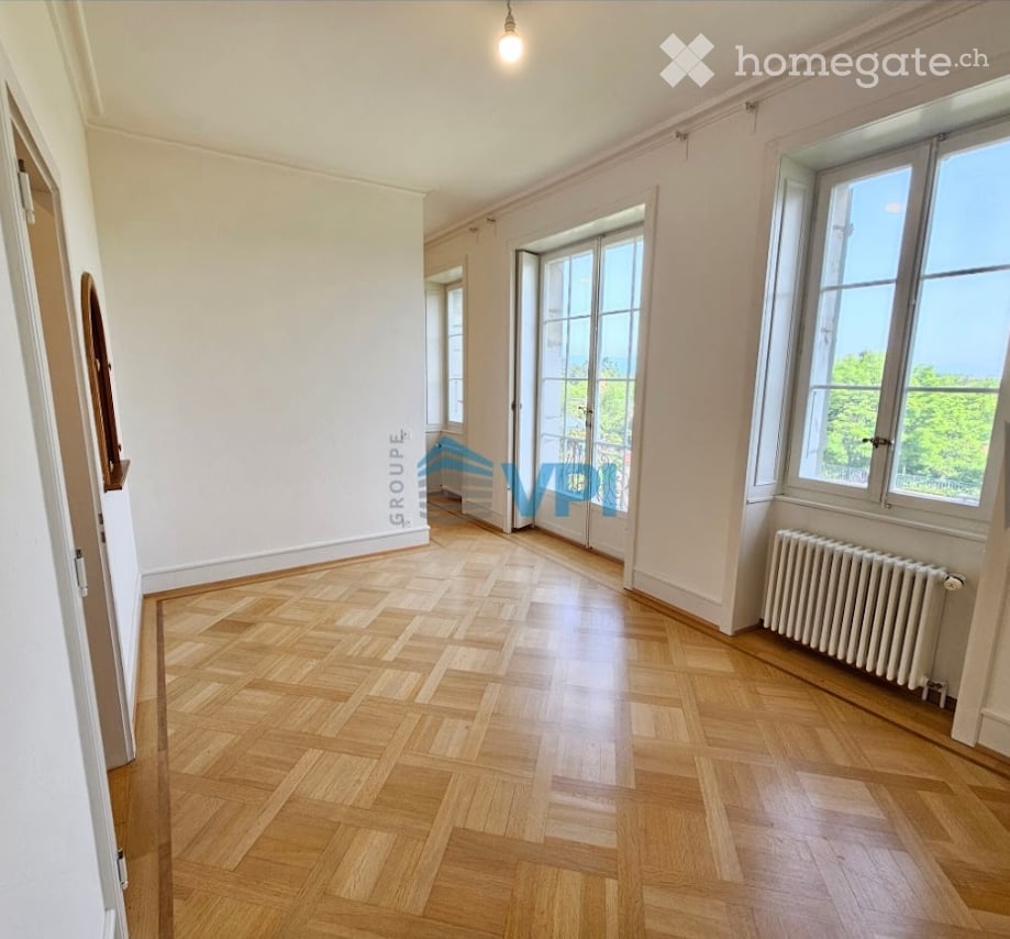 white walls, wooden parquet floor, glass windows, radiator, hallway