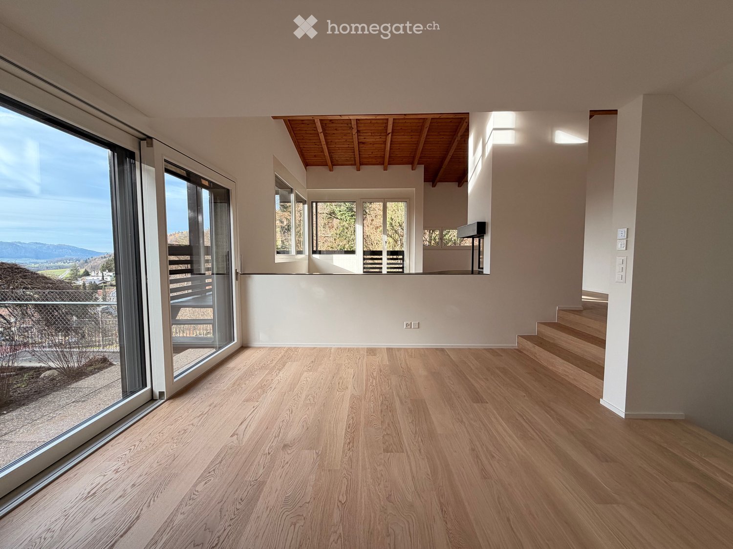 wooden floor, large windows, staircase, balcony