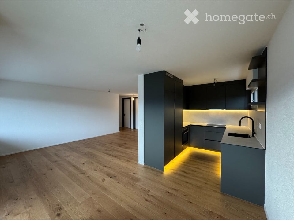 modern open plan kitchen with a sink, cabinets, countertop, and yellow LED lighting, hardwood floor