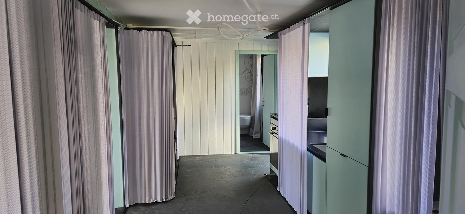 Corridor between rooms with white walls and curtains