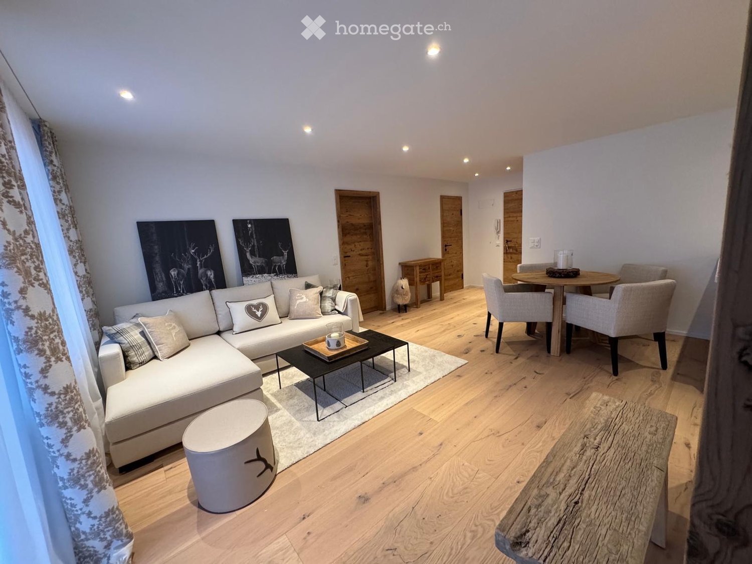 large white sofa, coffee table, white rug, wooden floor, dining table and chairs, modern decor