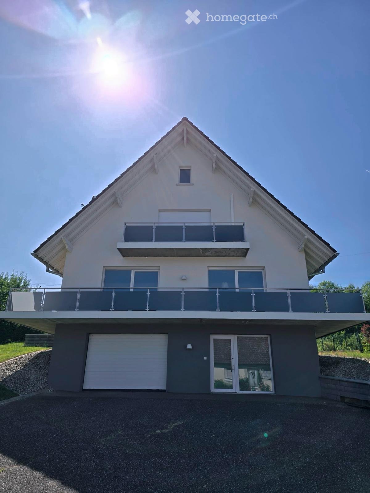 Modern 2-story house, white exterior, garage, balconies, driveway