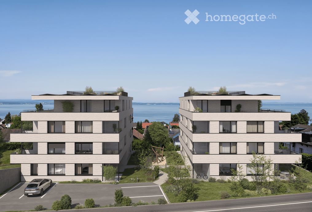 Modern multi-storey residential building, light colored exterior, windows, sea view, outdoor area, bicycles, parking lot, greenery