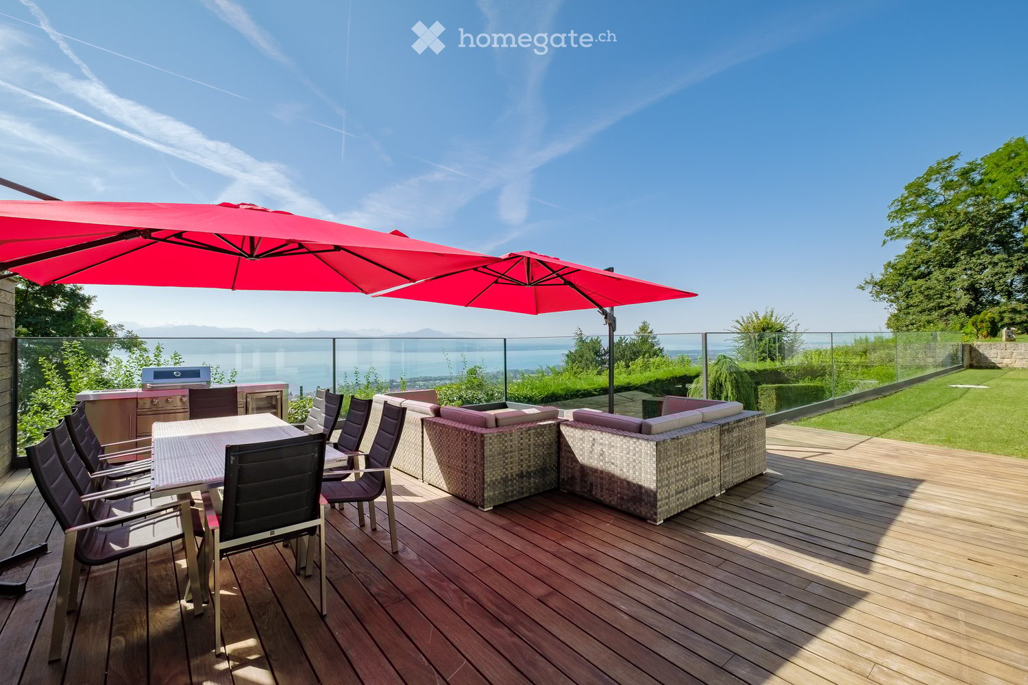 deck with table and chairs, large umbrellas, grill, sofa, railing, panoramic view