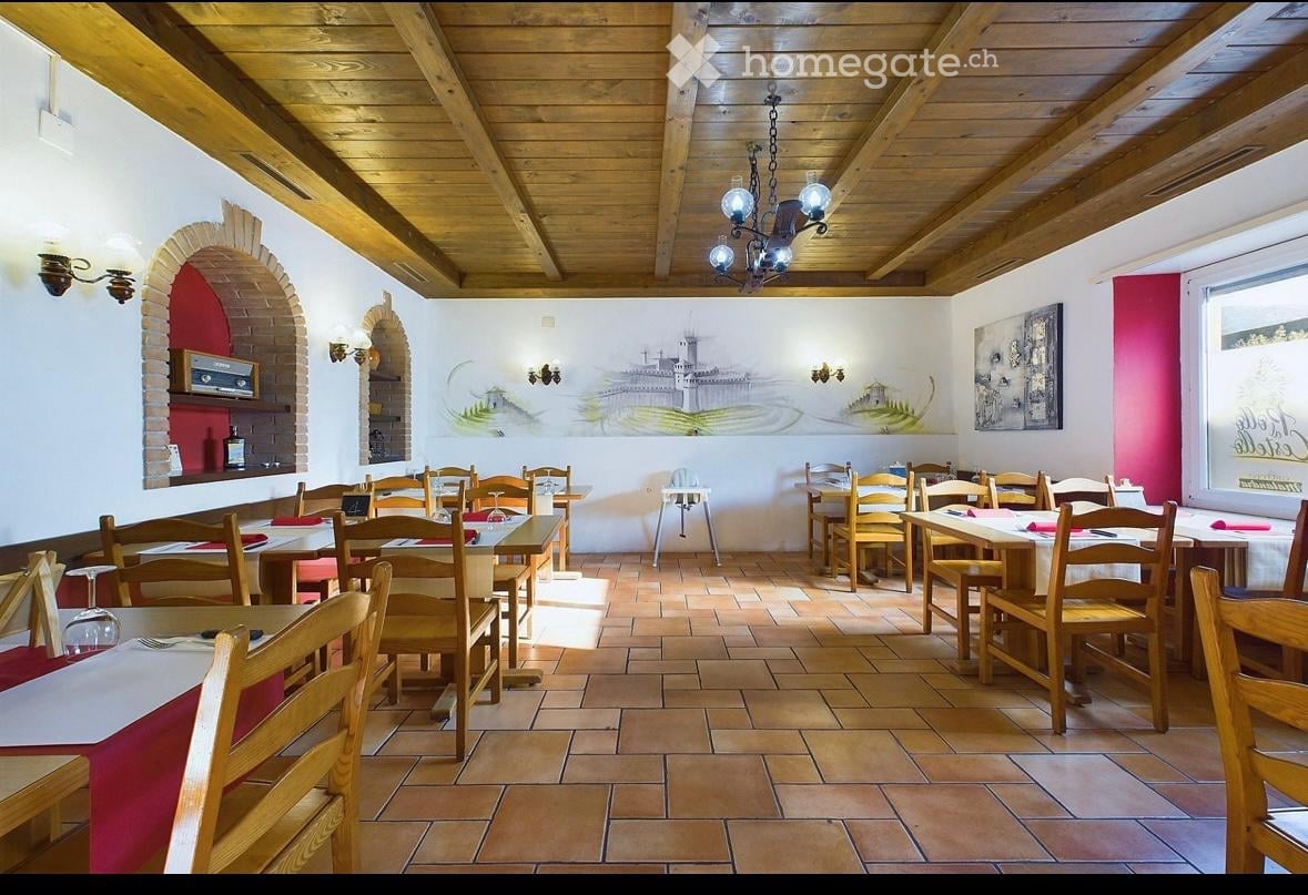 wooden chairs, long tables, tiled floor, wooden beam ceiling, lamps, artwork