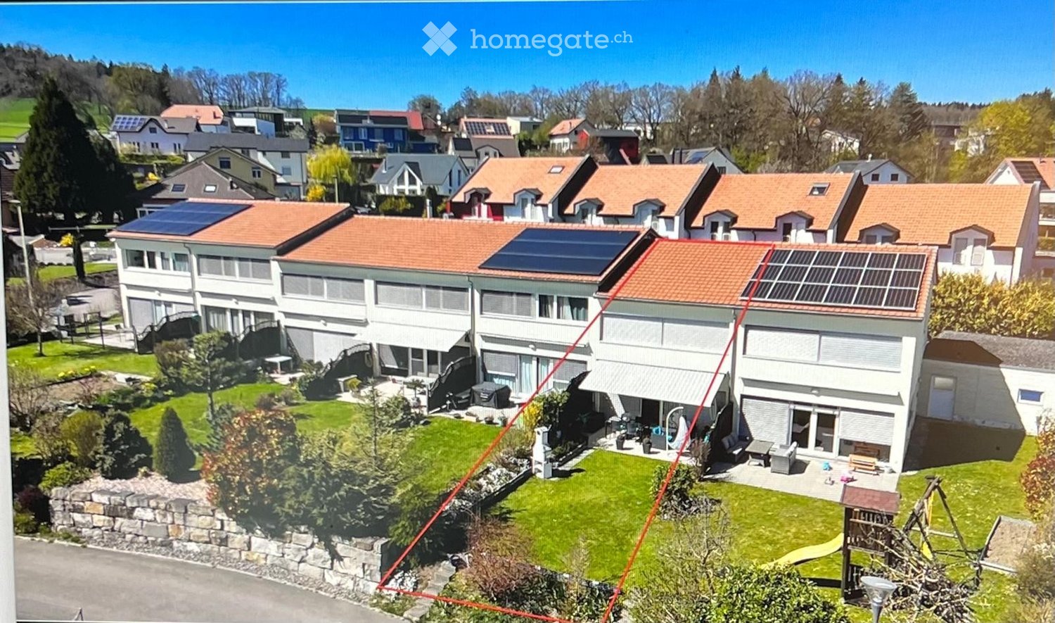 Apartments with solar panels, garden, playground, green hills in the background