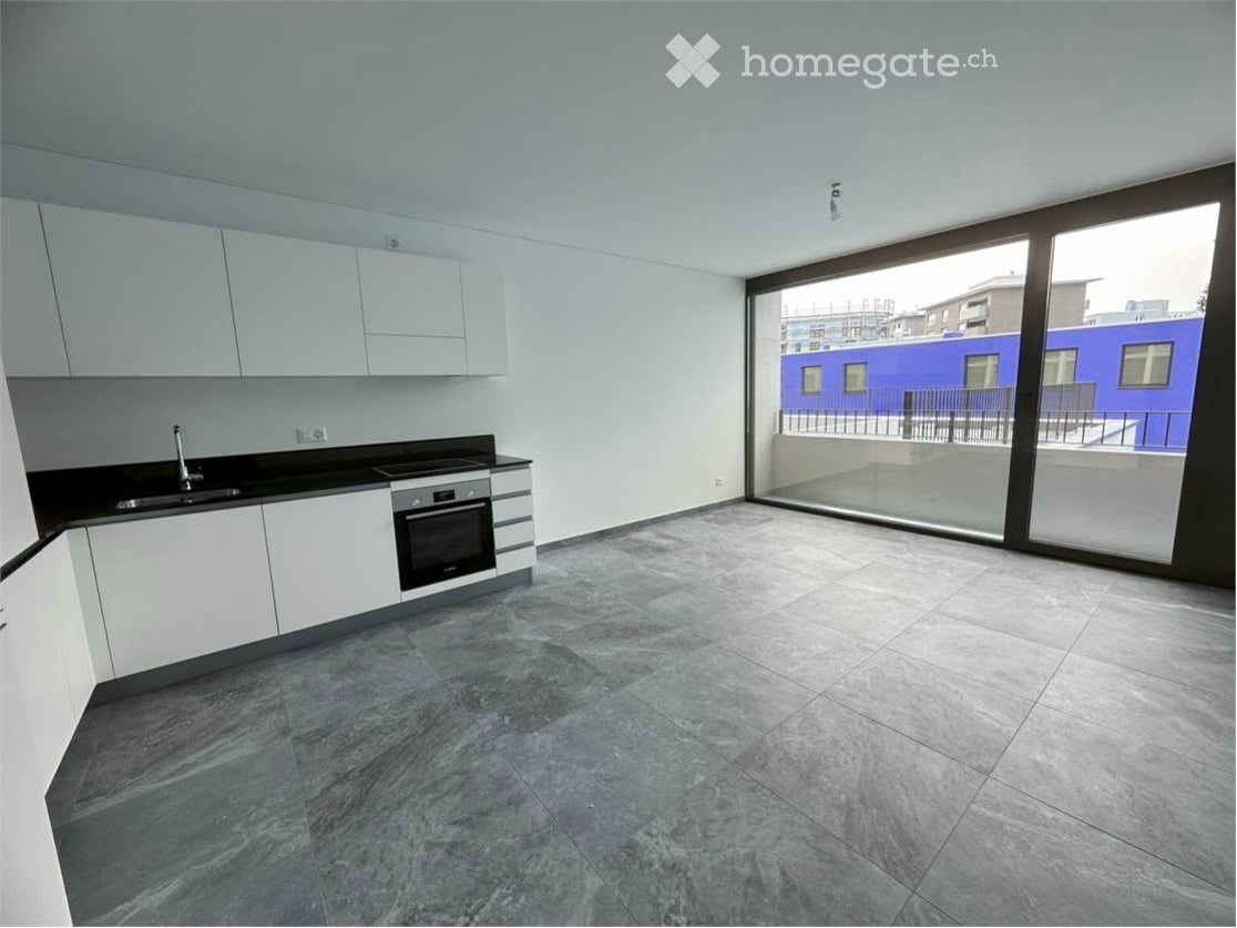 Modern kitchen, white cabinetry, granite countertop, large window with sliding glass doors leading to balcony