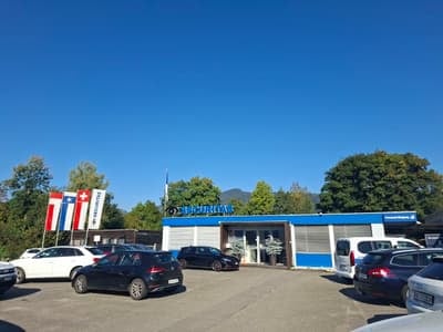 A commercial building with several cars parked in front of it.