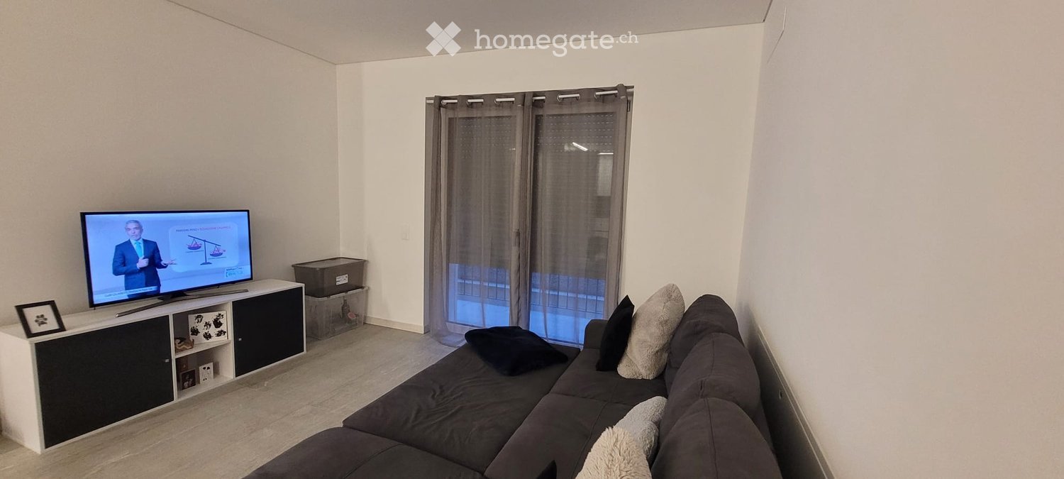 large sofa, black, flatscreen tv, curtains, picture frame