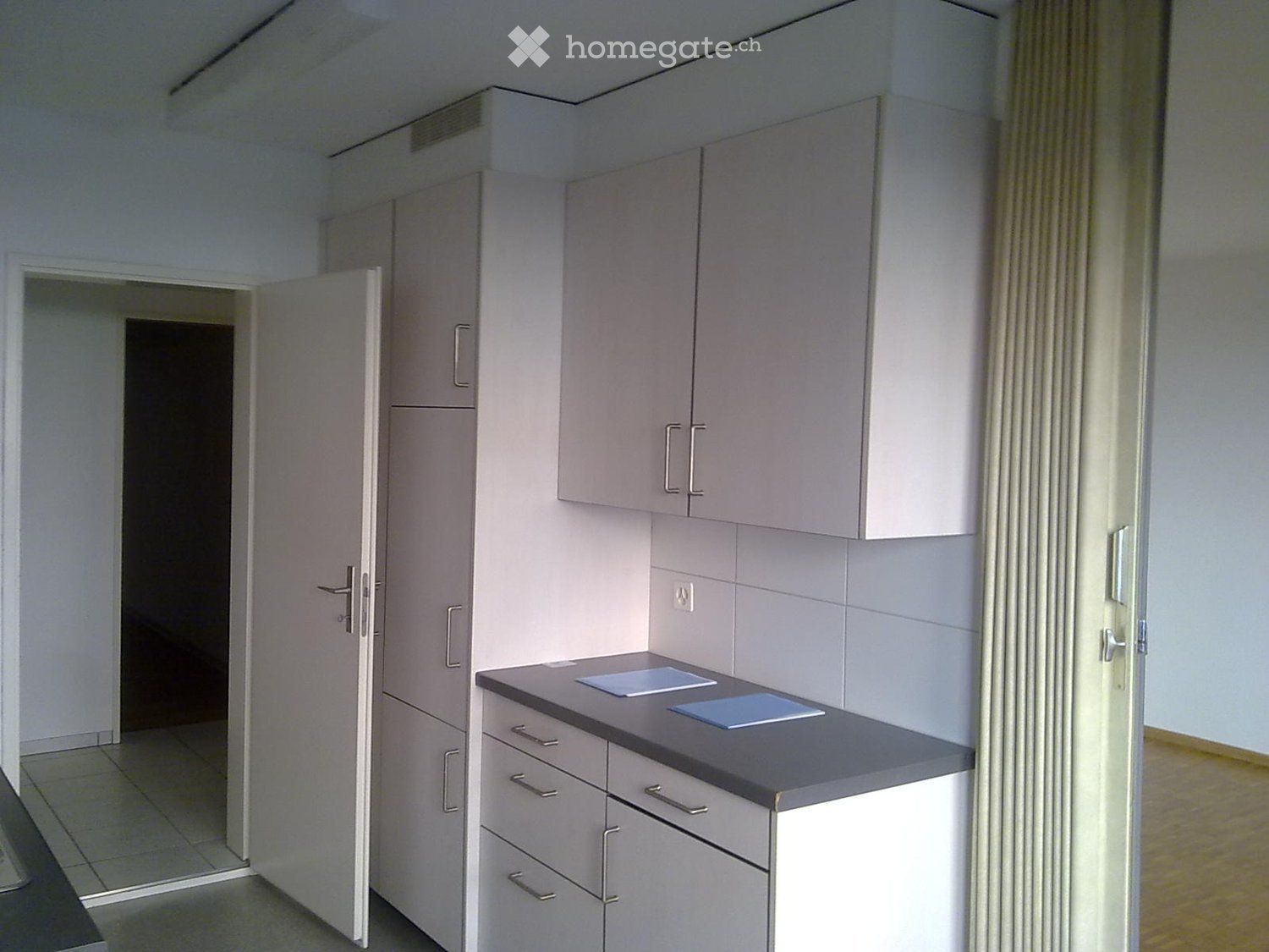 Modern kitchen with white cabinetry, stainless steel sink, dishwasher, electric stove, refrigerator