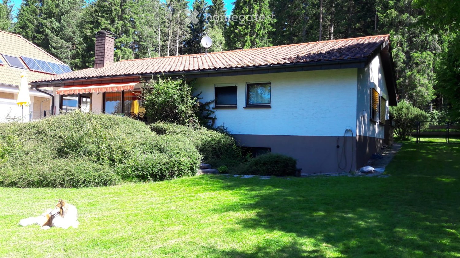 2 story house, red brick, white windows, solar panels, satellite dish, balcony, garden, pool, scenic view
