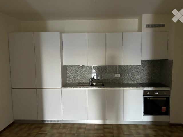 modern kitchen with white cabinets, tiled backsplash, countertop with sink and faucet, integrated oven and dishwasher