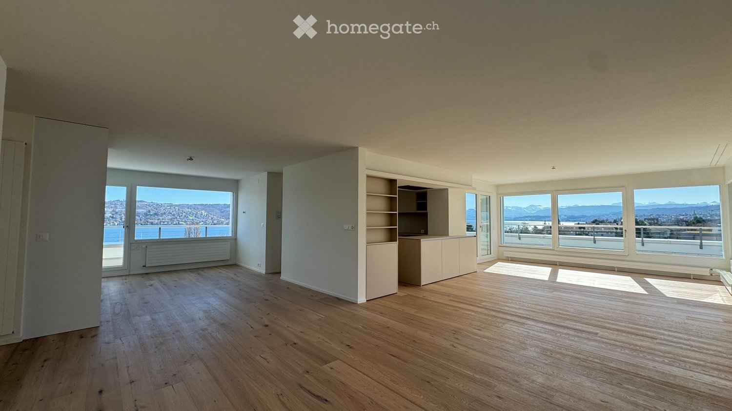 modern apartment, wooden floor, large windows, view of the city and mountains