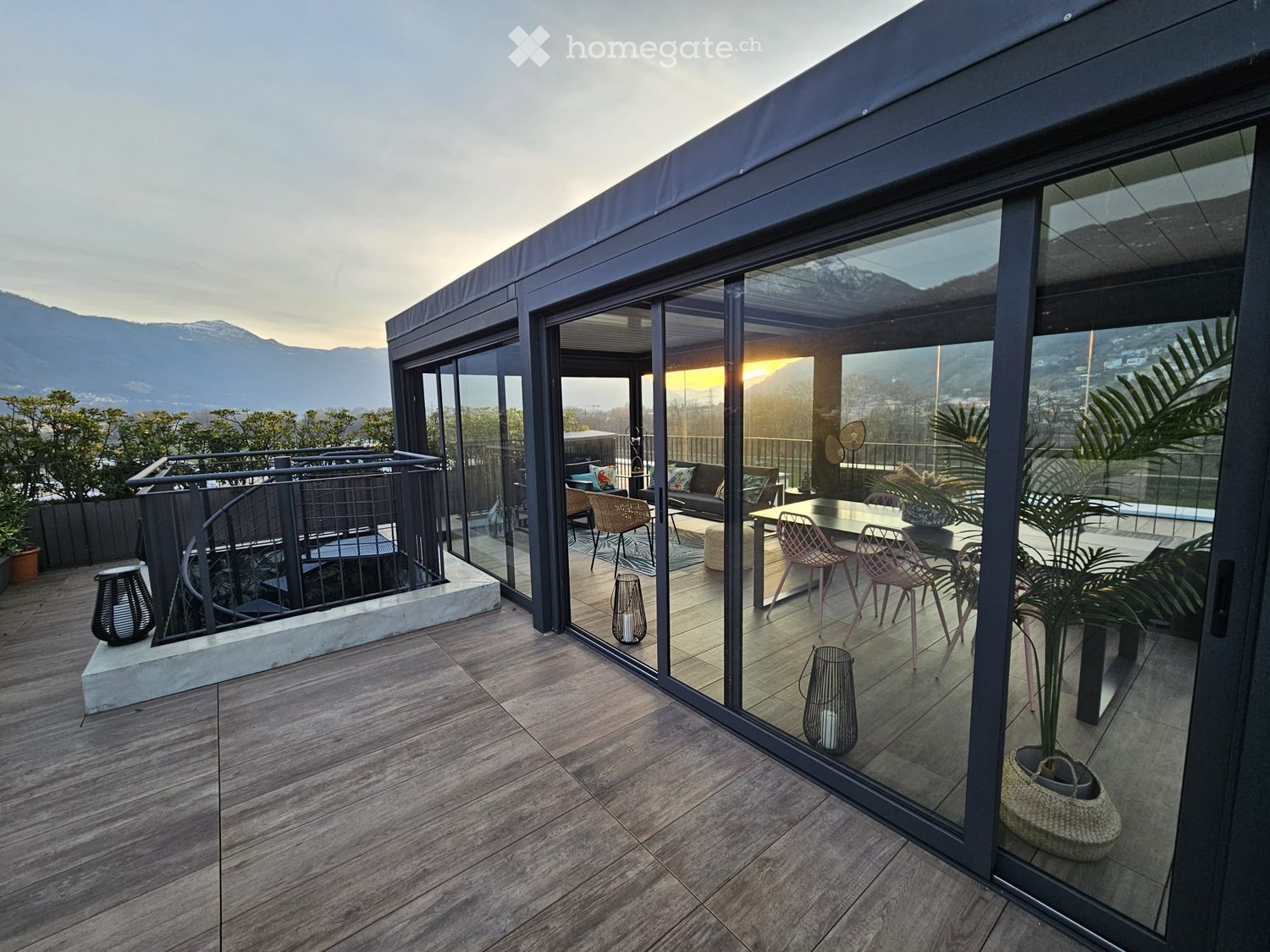 Balcony / Terrace with wooden flooring, metal railings, large glass doors, outdoor furniture, plants, panoramic view