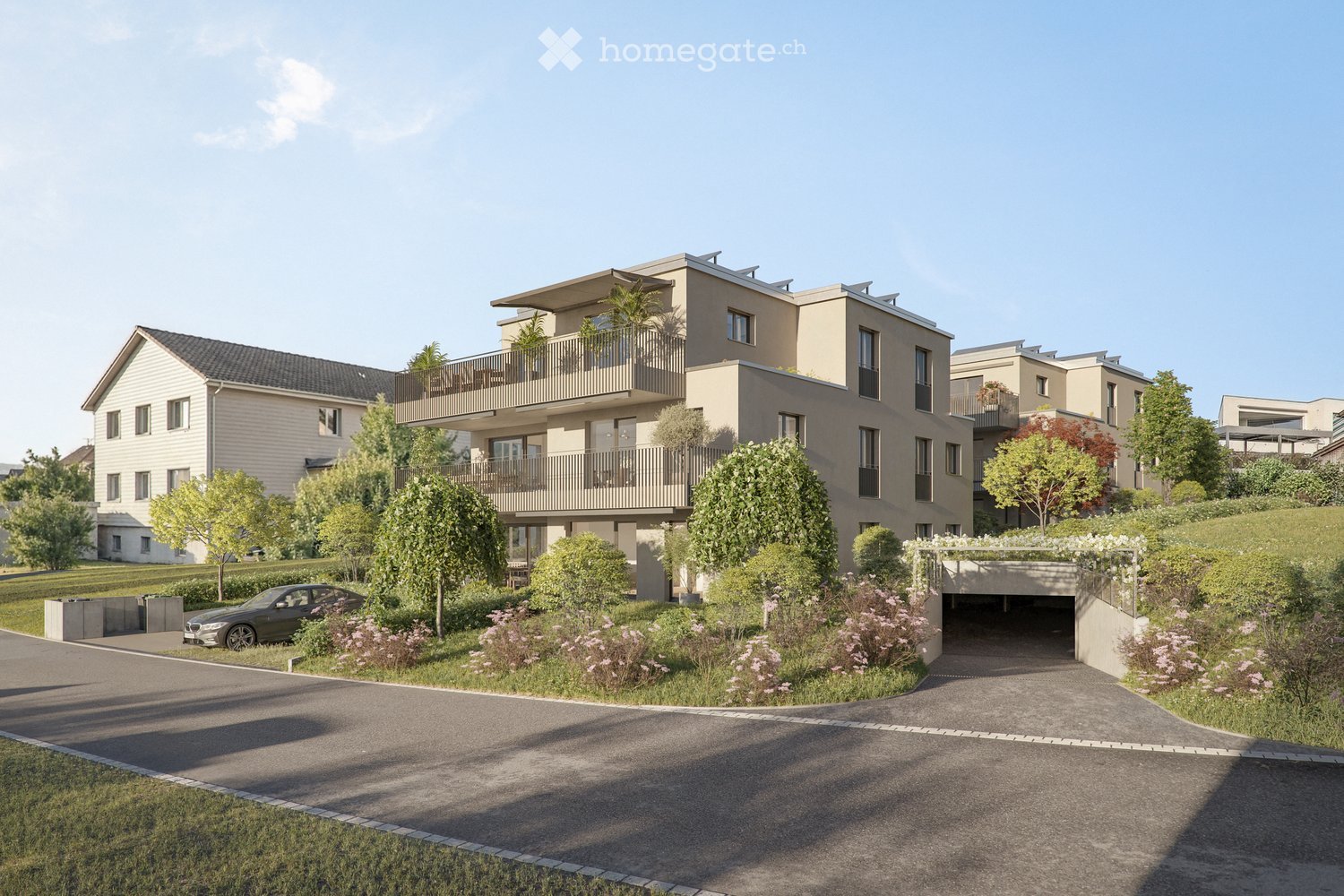 Multi-story building, beige walls, balconies, solar panels on the roof, driveway with a car, greenery, pathway, paved area