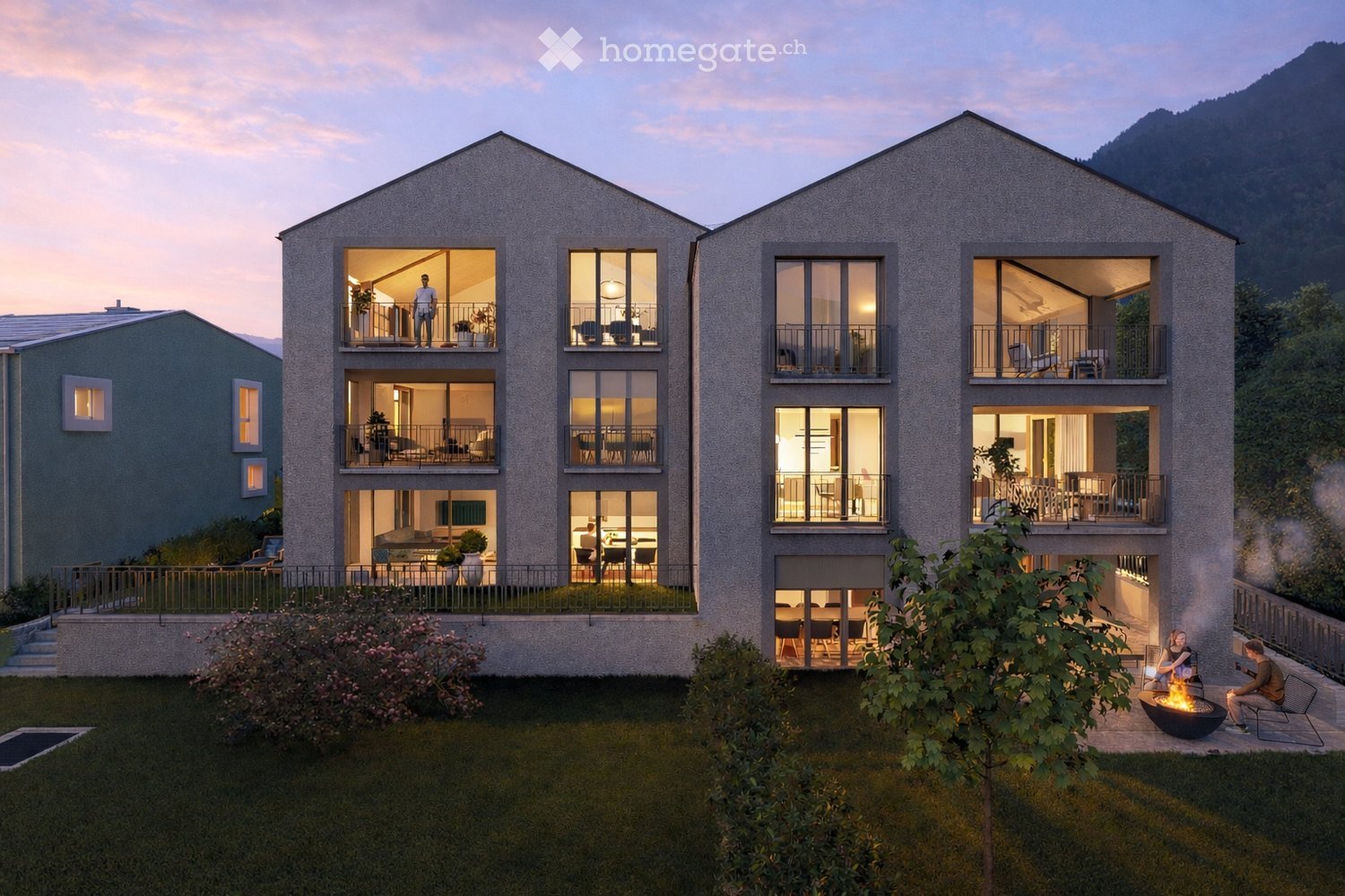 Modern apartment building with multiple balconies, large windows, and a view of the mountains