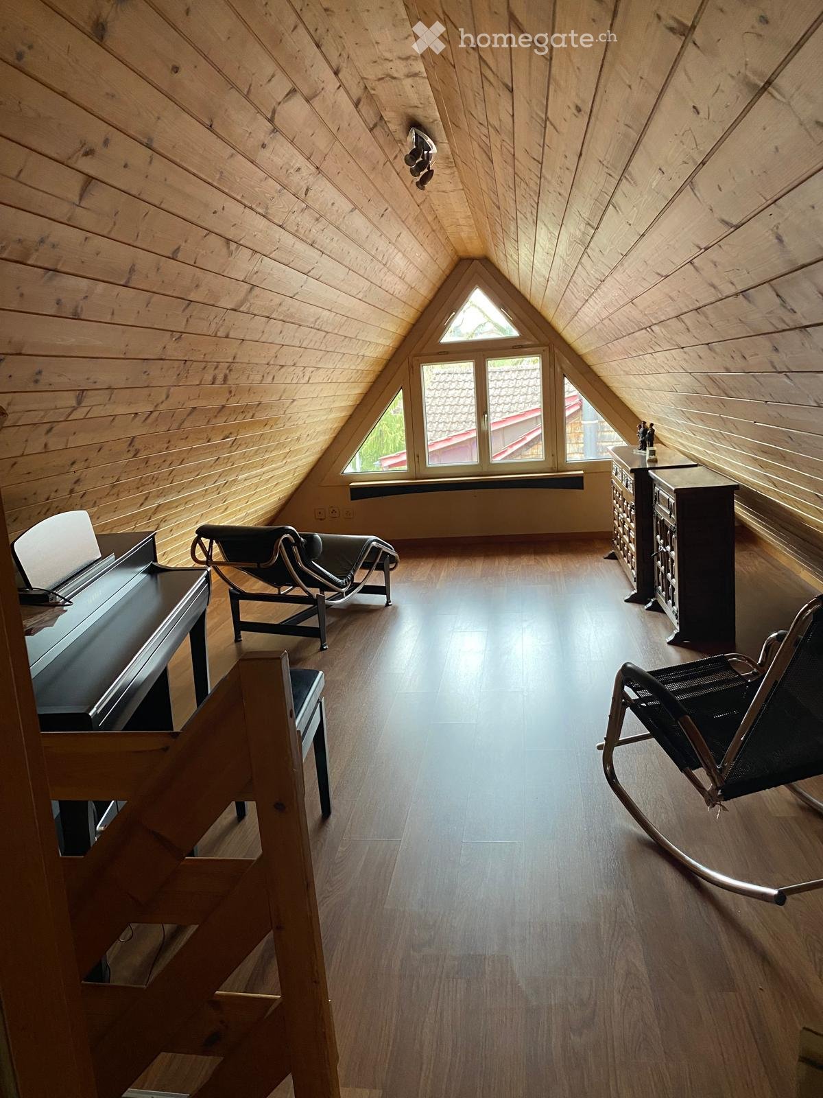 wooden ceiling, wooden floor, piano, lounge chair, cabinet, rocking chair