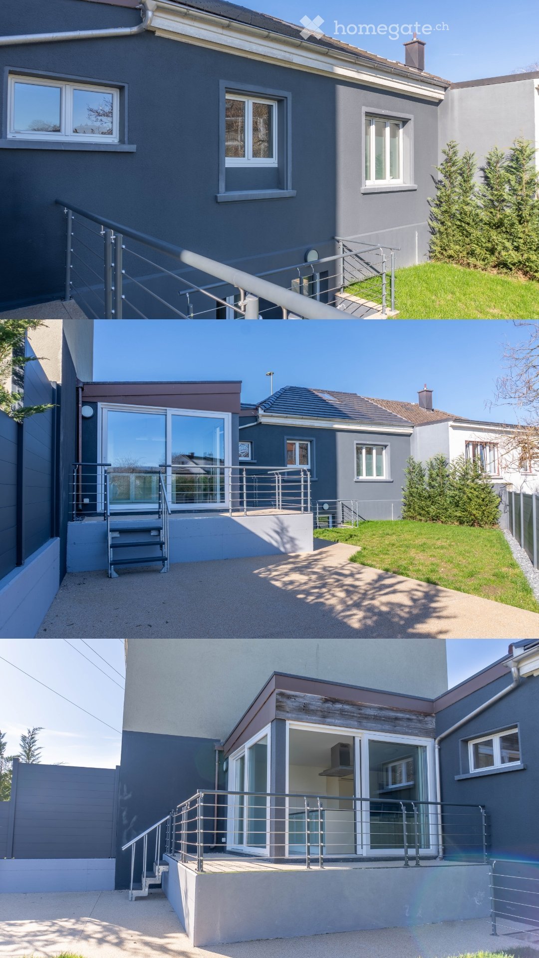 Modern house, gray exterior, large windows, metal railings, two balconies, driveway