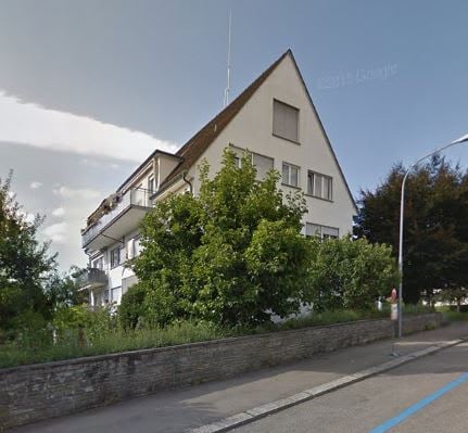 3 story house, white exterior, brown roof, balconies, street view