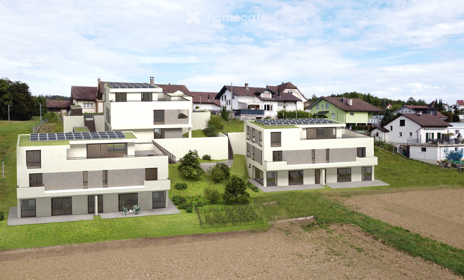 Modern apartment complex with solar panels on the roofs, raised ground floor, surrounded by greenery and a field