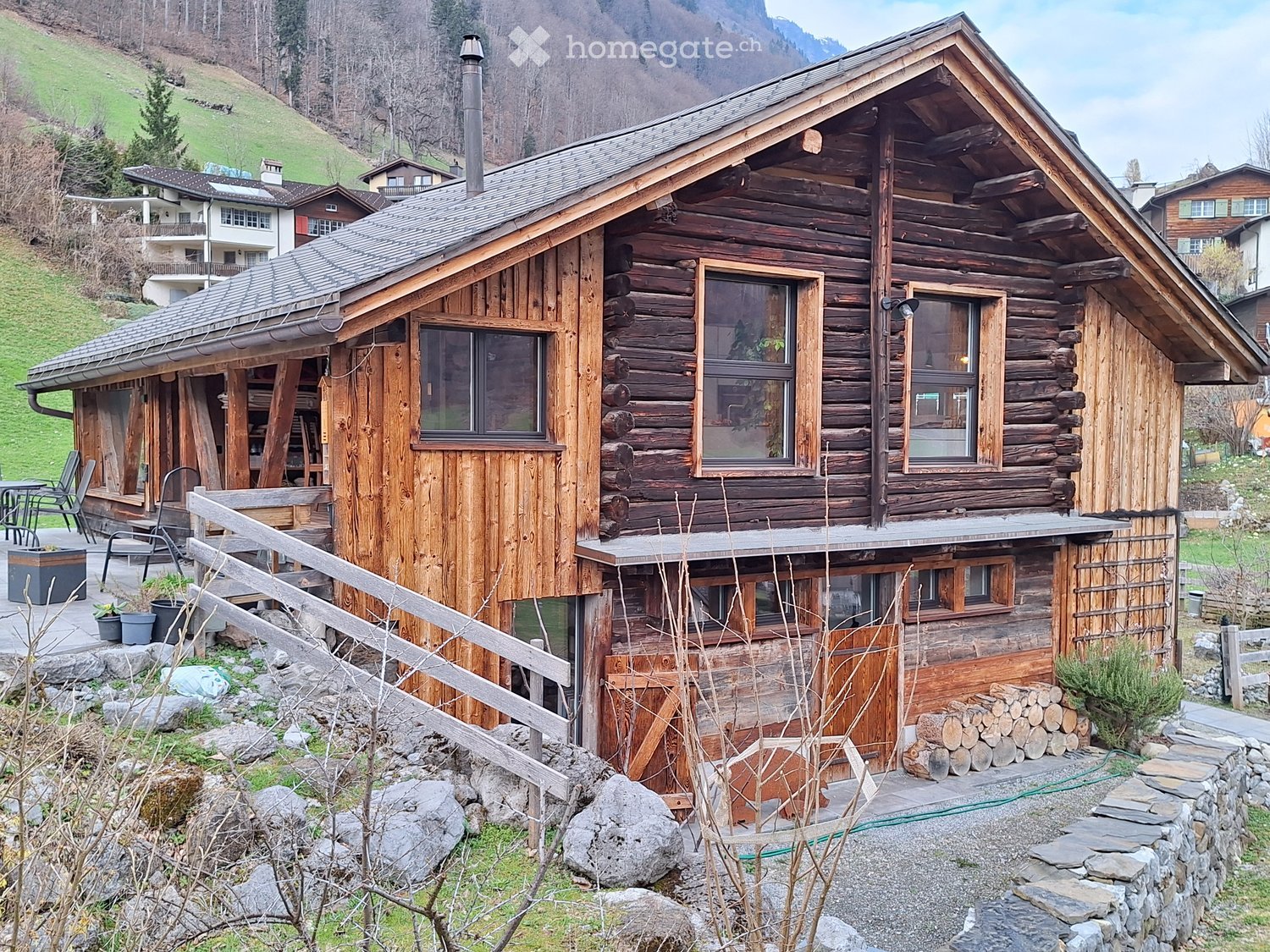 wooden chalet, 2 story, wooden exterior, chimney, wooden fence, wooden deck, garden, mountain view