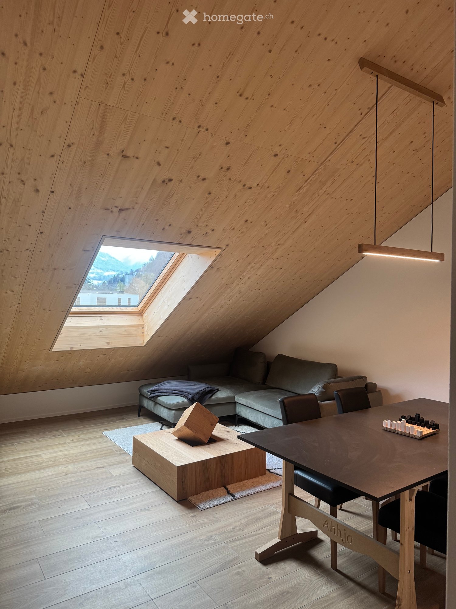 wooden ceiling, wooden floor, sofa, coffee table, dining table, chairs, skylight