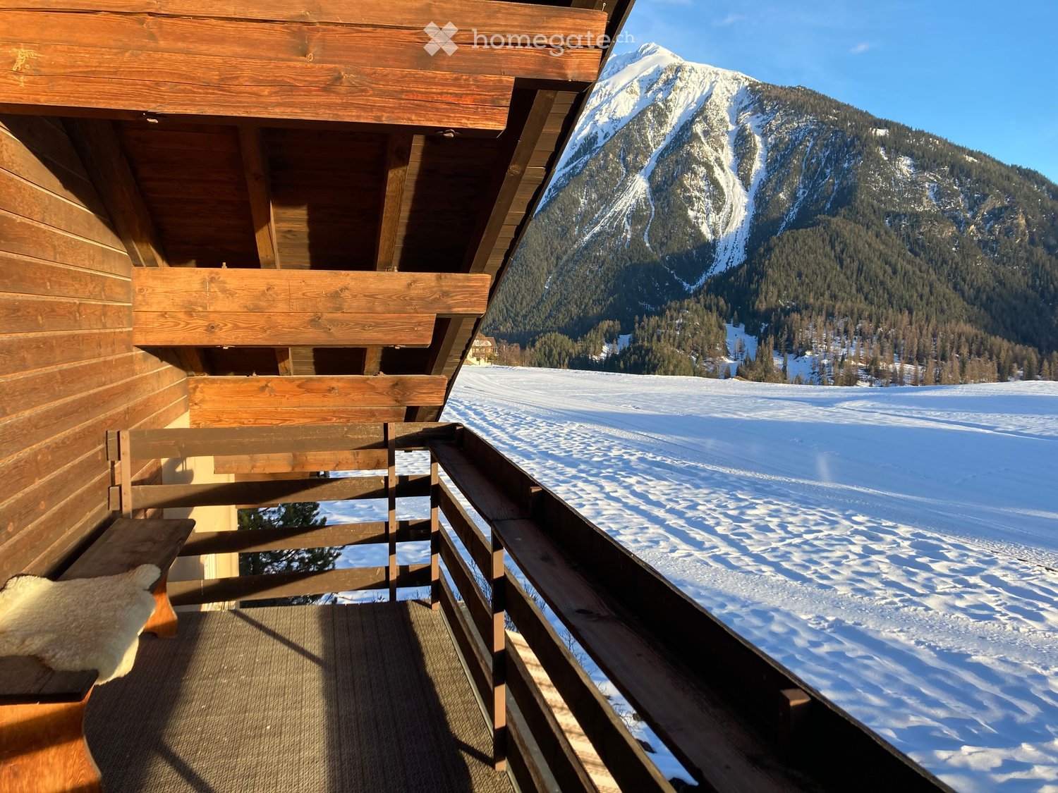 wooden balcony, wooden bench, wooden railing, snowy mountain view
