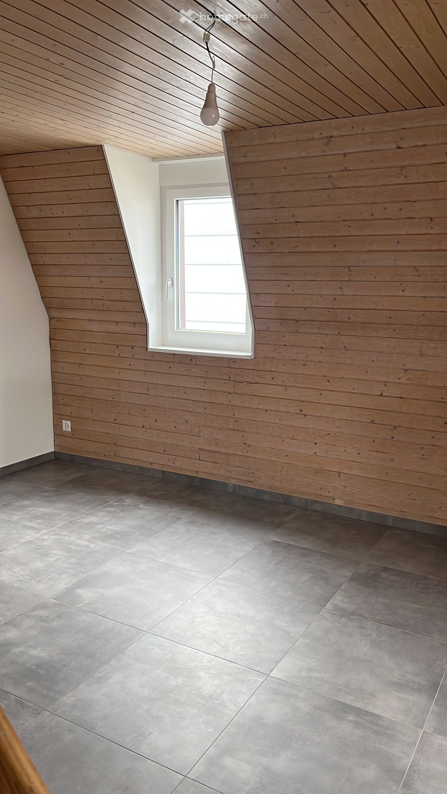 empty room, wooden walls, gray tiles, small window, ceiling lamp