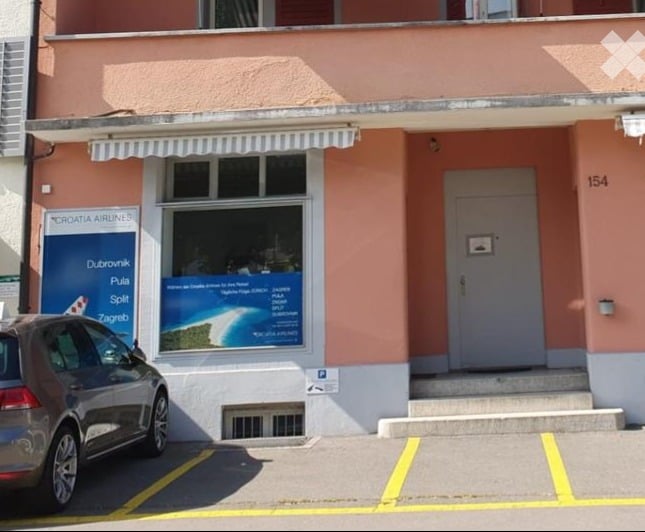 pink building, Croatia Airlines advertisement, parking space, entrance door, steps