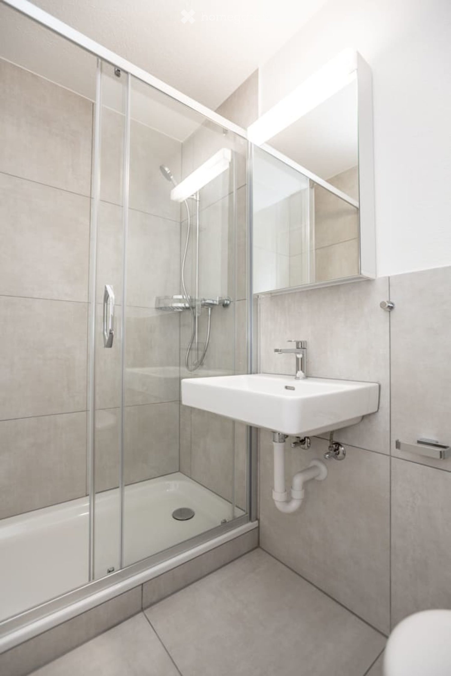 modern bathroom with shower, sink, and toilet