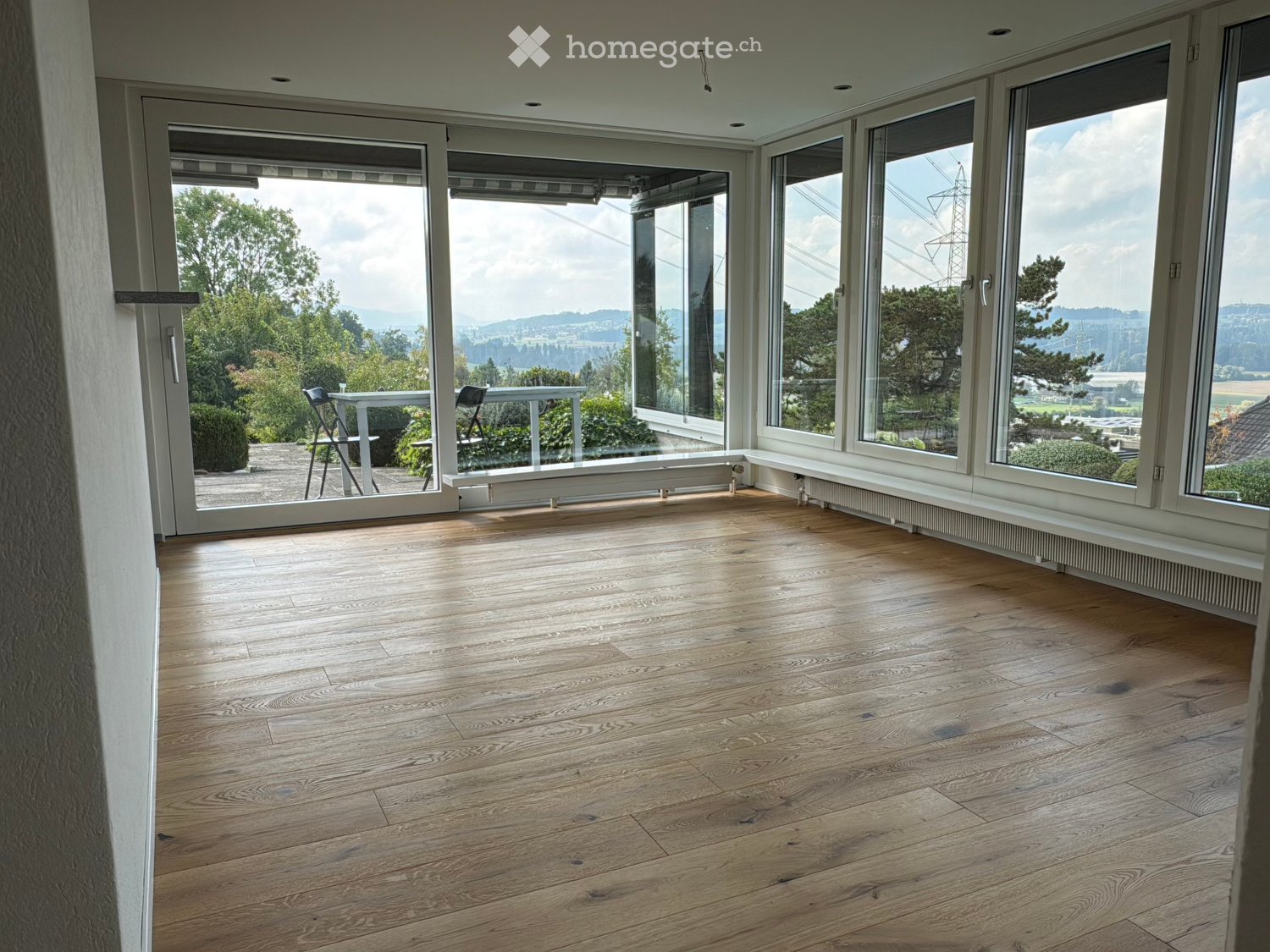 large windows, balcony, wooden floor, empty room