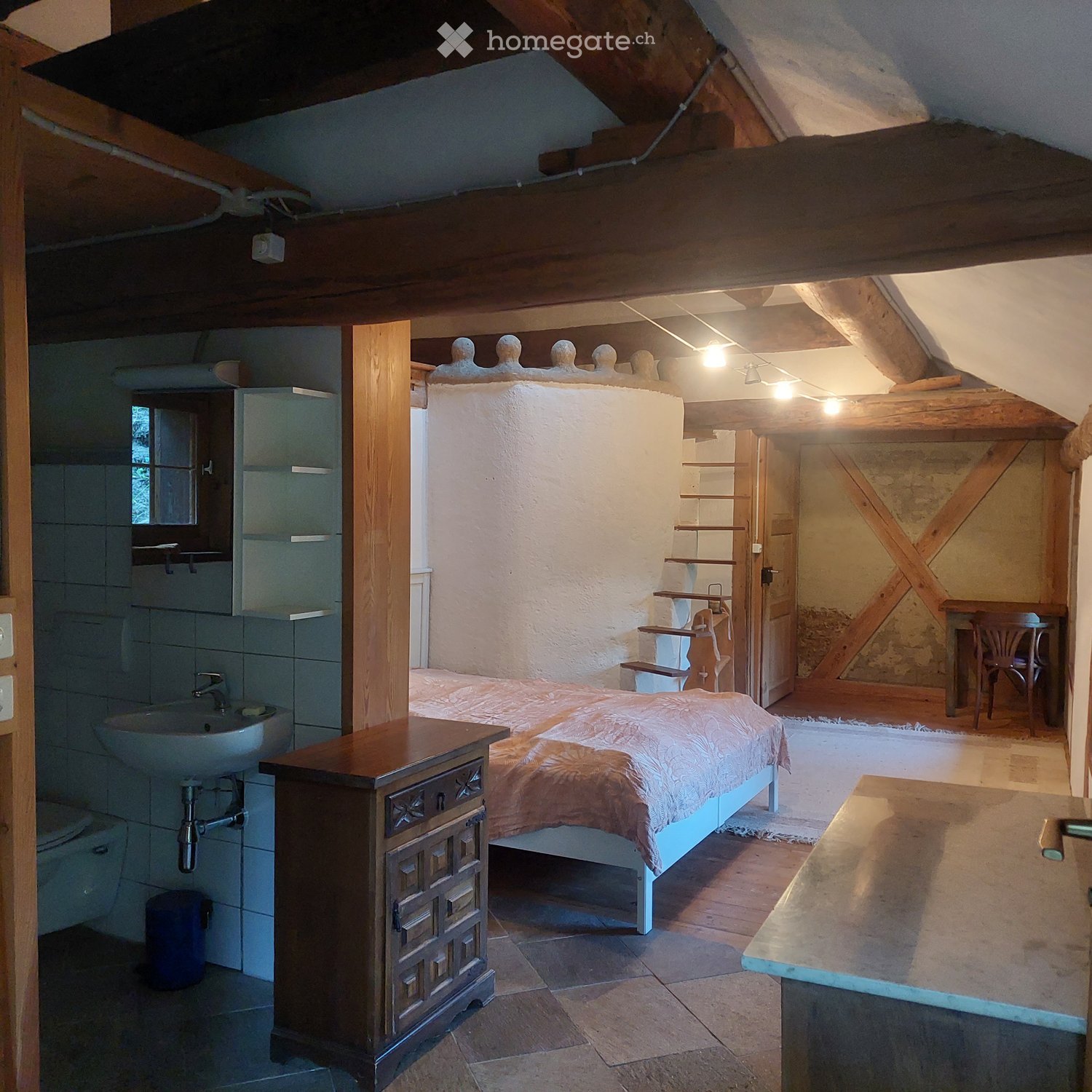 bedroom with bed, wooden cabinet, sink, toilet, wooden beams, wooden floor, small window