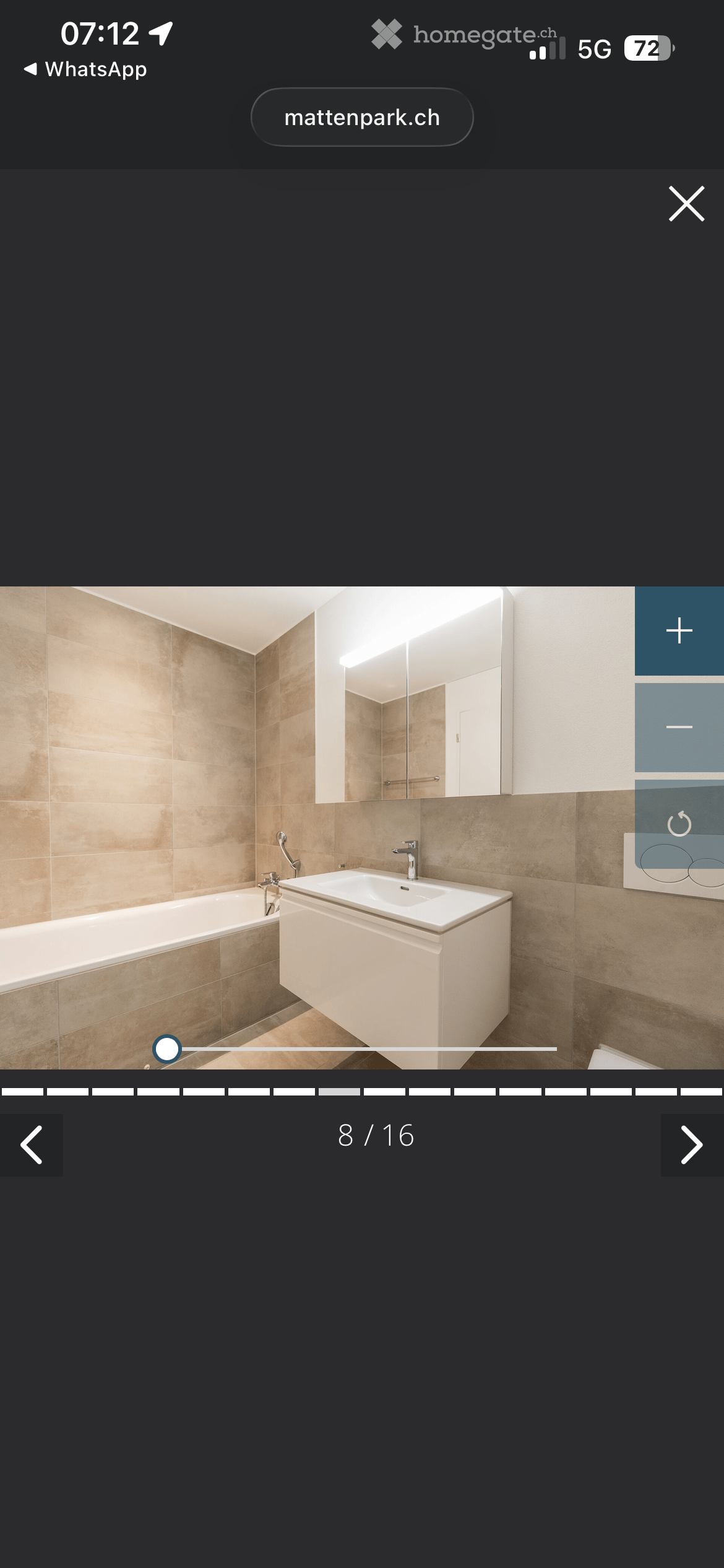 Bathroom with bathtub, sink, mirror, and tiled walls
