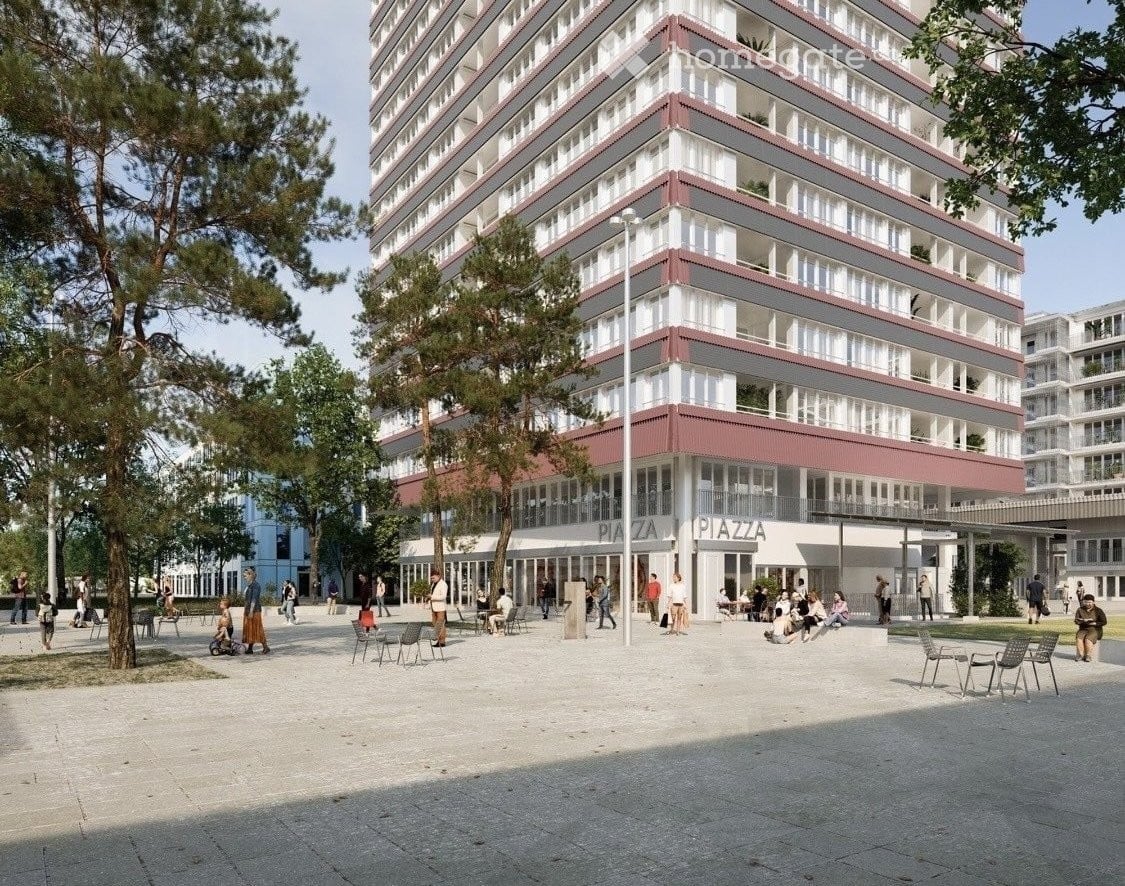 High-rise building with multiple floors, red and white exterior, large windows, outdoor seating area, trees, and street lights