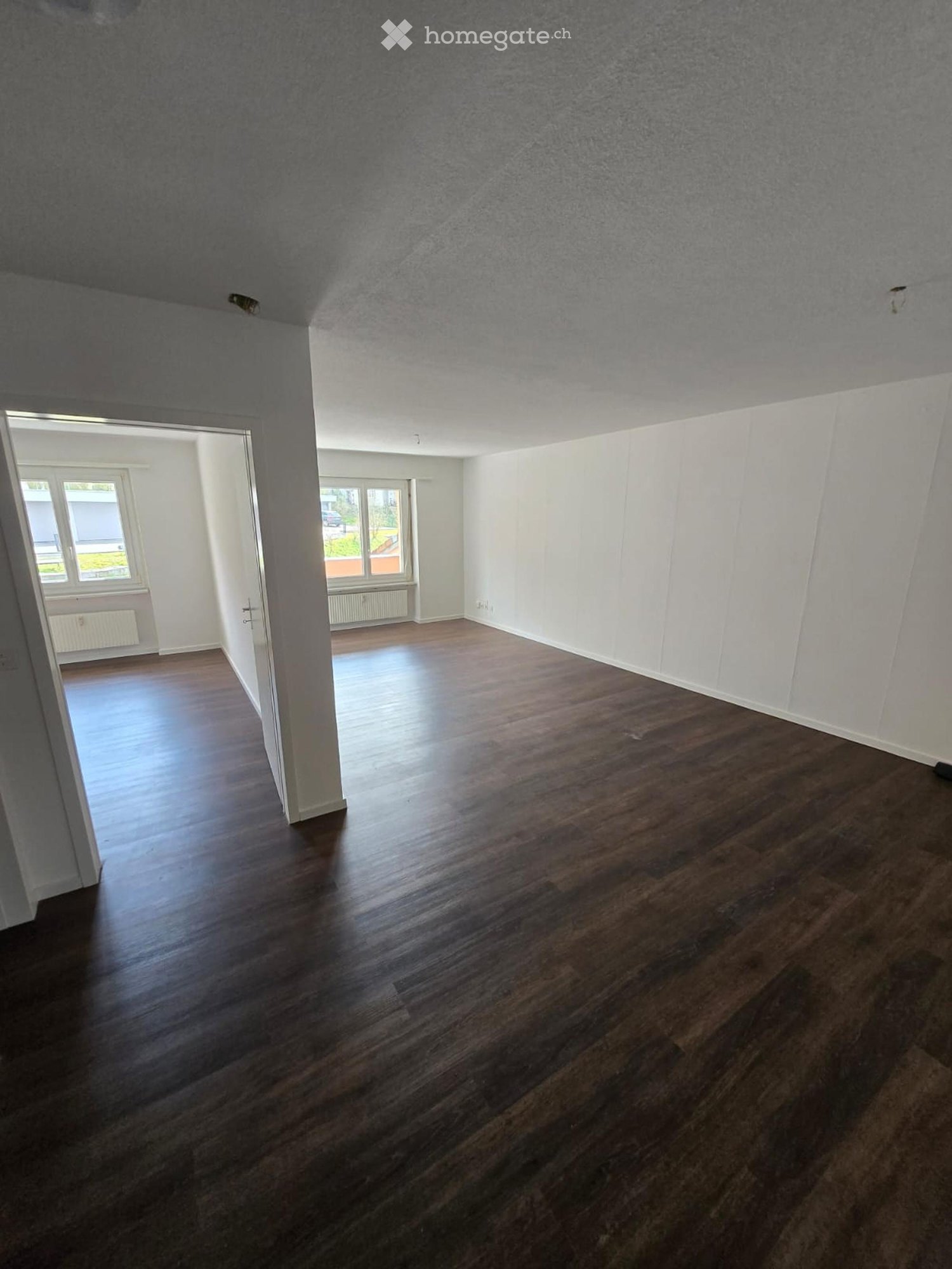 empty room, wooden floor, white walls, windows, radiators