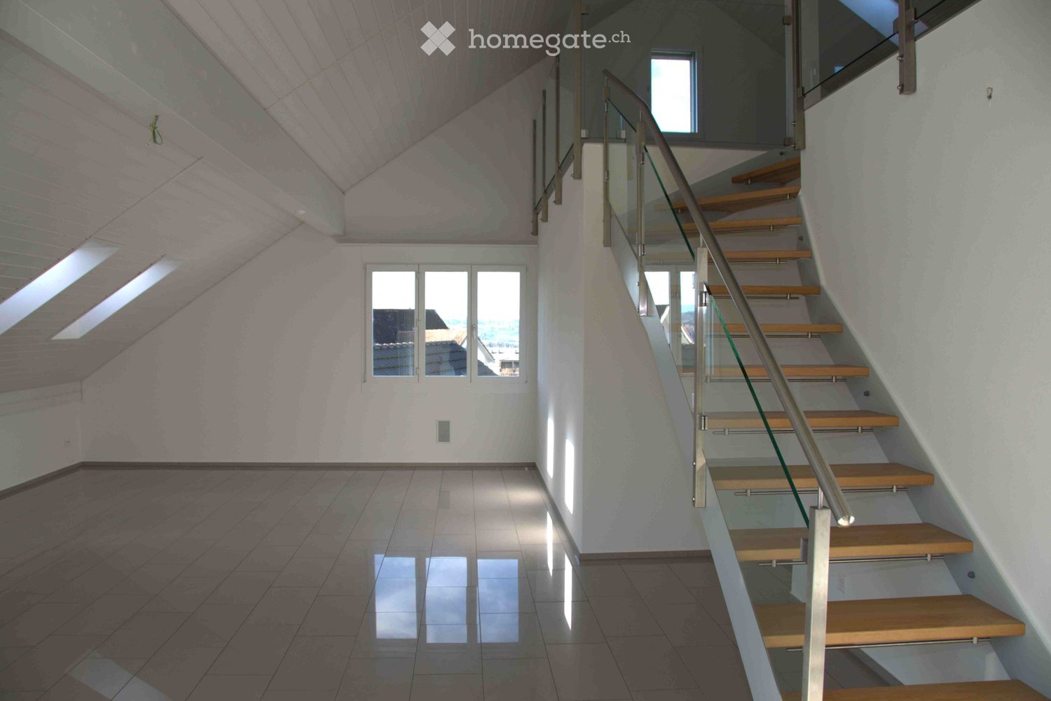 Tiled floor, white walls, staircase, glass window, sloped ceiling