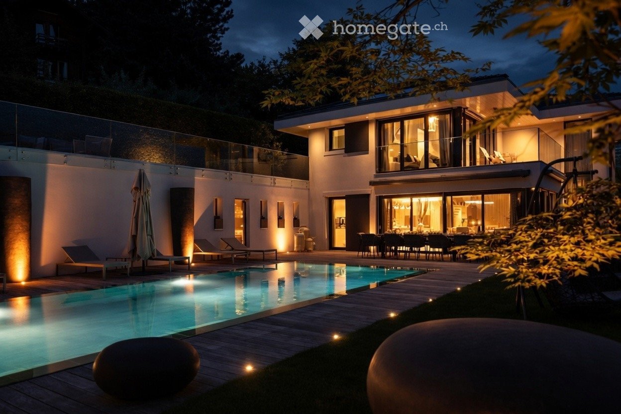 Modern house exterior with a swimming pool, outdoor seating area, and lounge chairs.