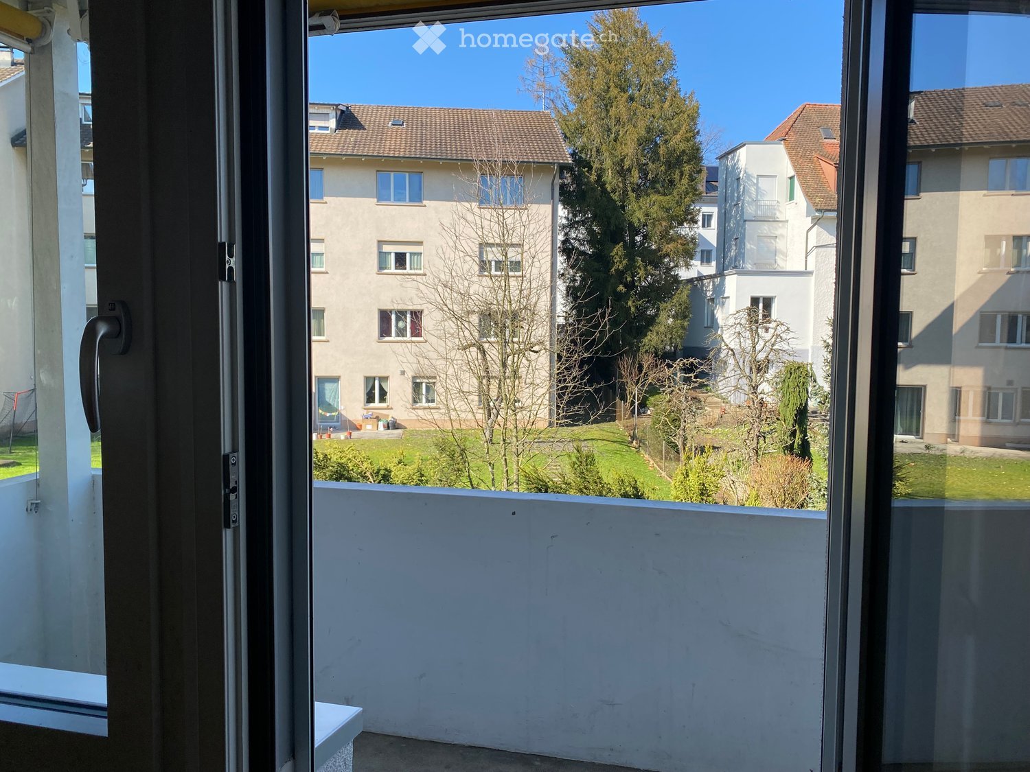 Balcony with a view of the garden and buildings