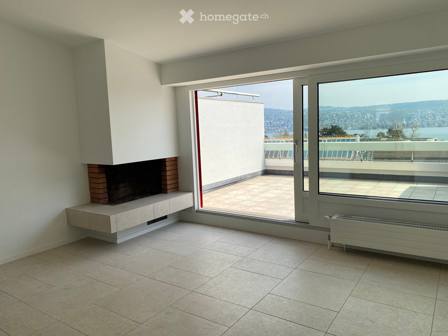 empty room, fireplace, sliding glass doors, balcony, tiled floor, white walls